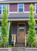 Two Slender Silhouette Sweetgum trees planted in retaining walls at the front entrance of a home flanking the stairs.